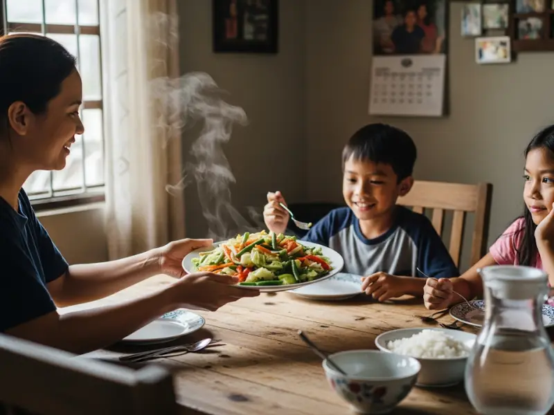 Filipino family eating sautéed vegetables at home.