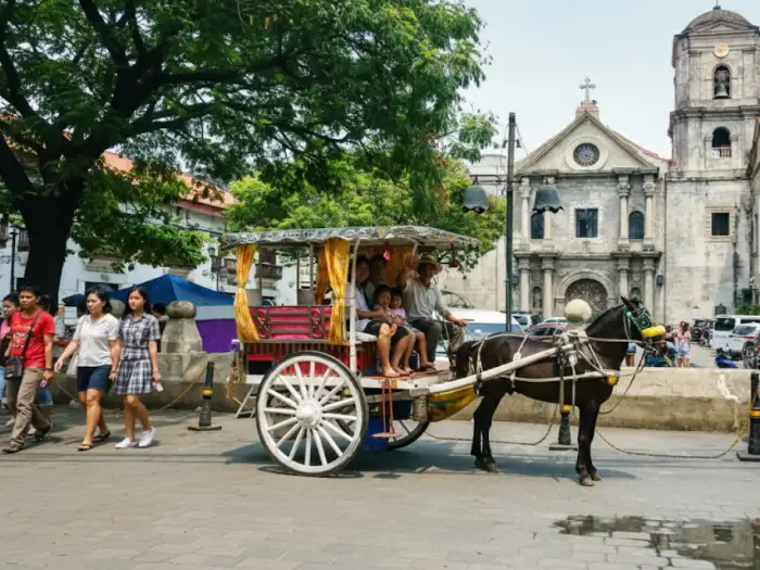 Intramuros kalesa ride experience photo showing tourists and locals exploring the Walled City.