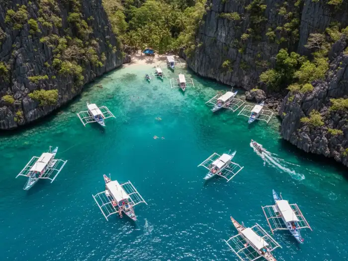 Aerial view of tour boats scattered across Bacuit Bay in El Nido.