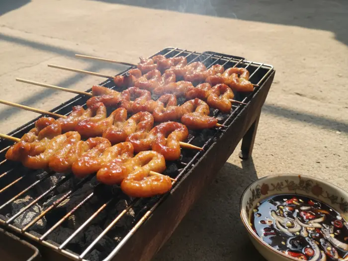 Grilled isaw skewers Filipino street food with spiced vinegar dip