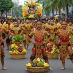 Tribal dancers in colorful red and gold costumes performing at the Kadayawan Festival in Davao City.