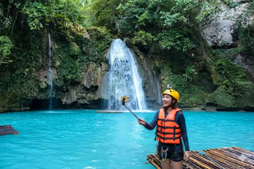 kawasan falls canyoneering adventure badian cebu Filipina enjoying a selfie in the turquoise waters at Kawasan Falls in Badian, Cebu.