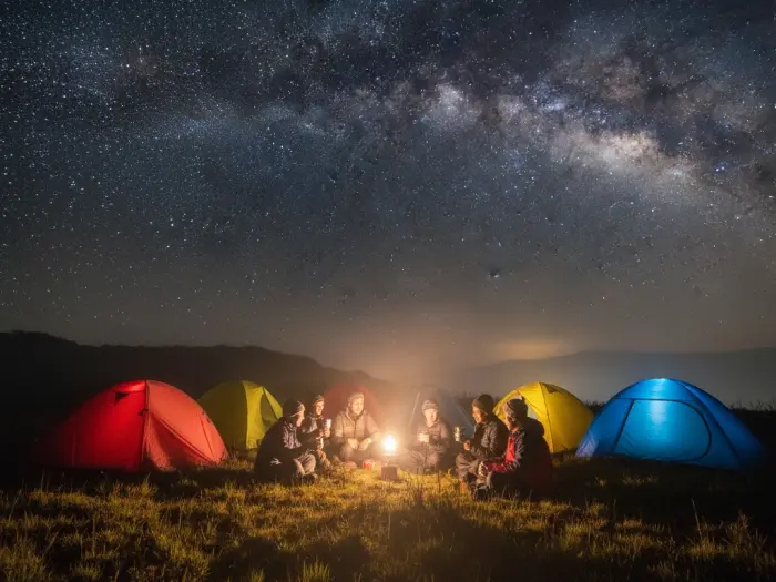 Filipino hikers camping at Mount Pulag under the stars with tents and warm jackets.