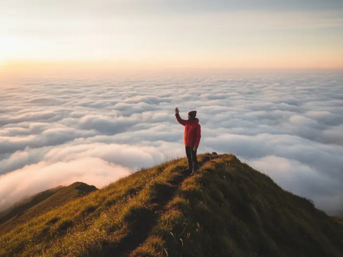 Filipino hiker overlooking the golden sunrise and sea of clouds at Mount Pulag.