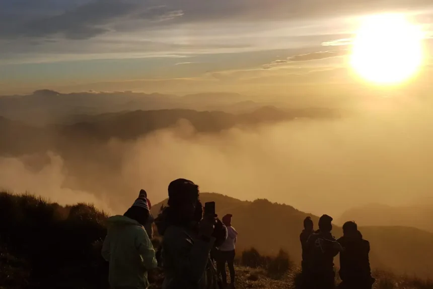 mount pulag sea of clouds sunrise hike philippines Filipino hikers enjoying the sunrise above the sea of clouds at Mount Pulag’s summit.