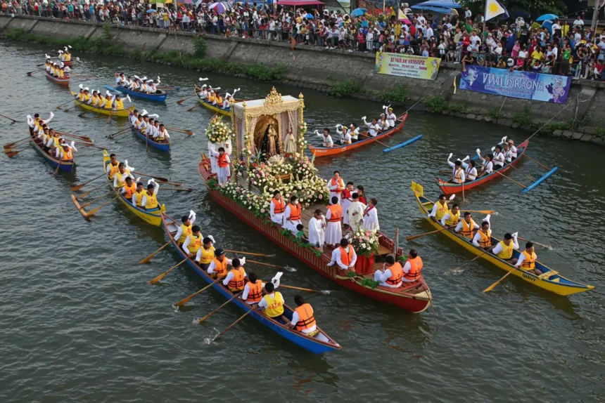 Voyadores escort the image of Our Lady of Peñafrancia on the Naga River during the fluvial procession.
