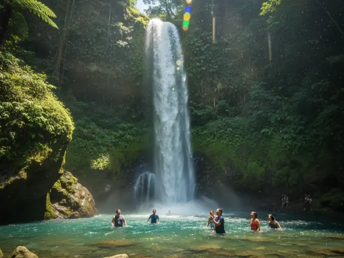 Tourists enjoying the misty waters of Tumalog Falls near Oslob, Cebu.