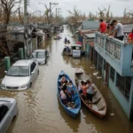 Drone view of typhoon aftermath showing flooded Philippine streets and affected families.