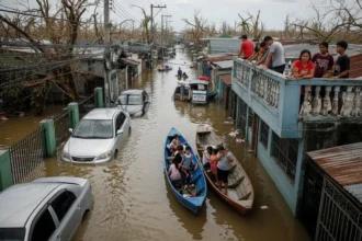 Drone view of typhoon aftermath showing flooded Philippine streets and affected families.