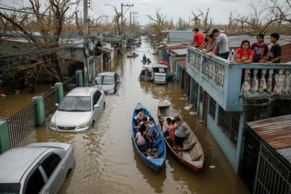 Drone view of typhoon aftermath showing flooded Philippine streets and affected families.