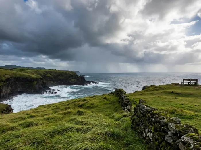 batanes travel guide weather seasons batanes A moody Batanes coastline with shifting clouds and rolling hills, created for a Batanes Travel Guide explaining the best time to visit the islands.